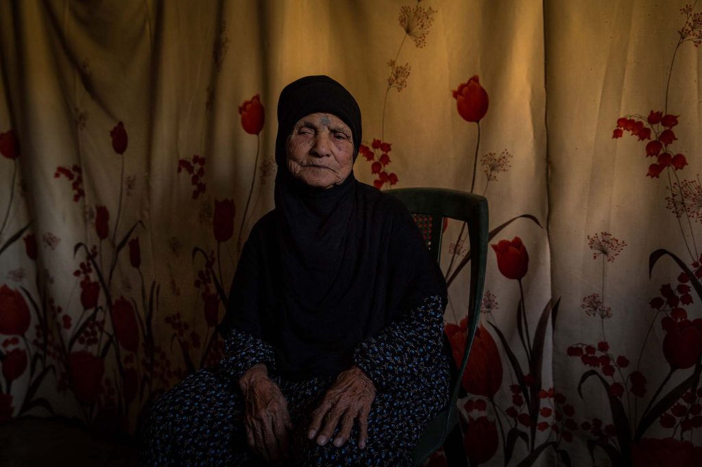 Bekaa Valley, Lebanon - 15/10/2016: 85 years old Sharifi had tattoos produced on her hands and face when she was 10. The Dom used to be famous for this but the new generation no longer practices this tradition. In Syria she lived in a tent with no chairs and moved into a concrete home when she was married at 15 years of age. She speaks Domari and is now living in a tented settlement in the Bekaa valley: “We had everything in Syria, now we have nothing. We are happy.”